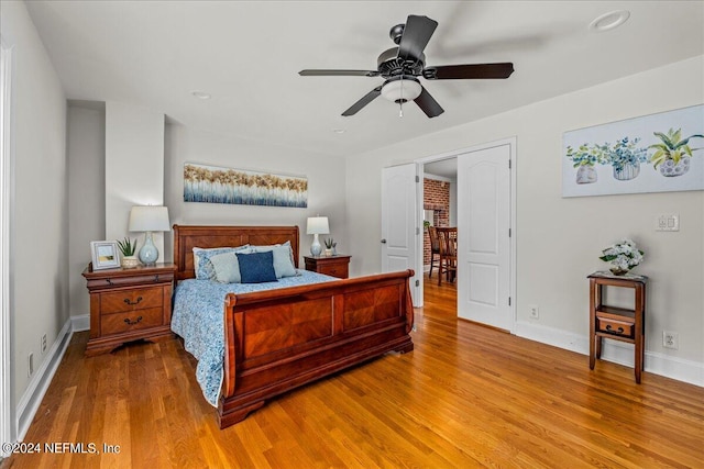 bedroom with ceiling fan and hardwood / wood-style flooring