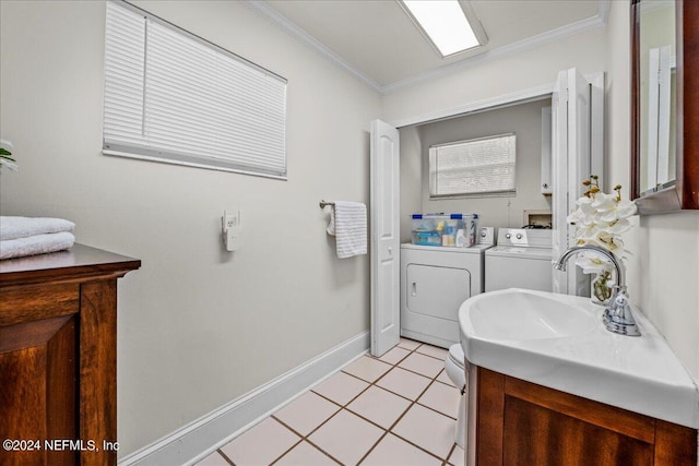 bathroom with washing machine and clothes dryer, tile patterned floors, vanity, and crown molding