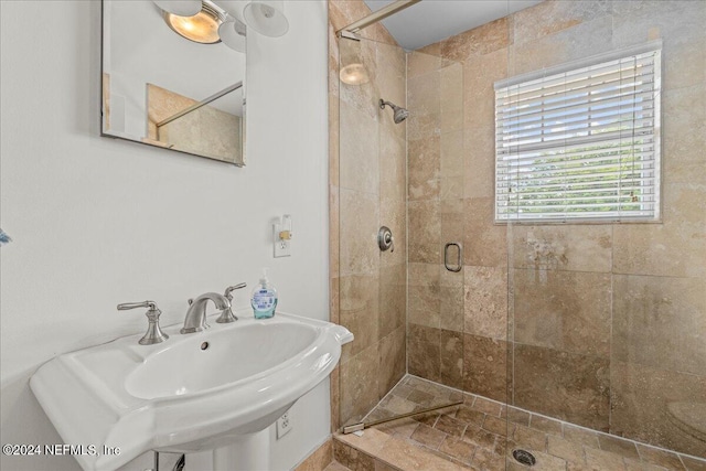 bathroom featuring sink and a shower with door