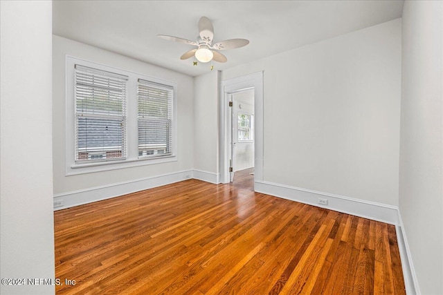 spare room featuring ceiling fan and hardwood / wood-style floors