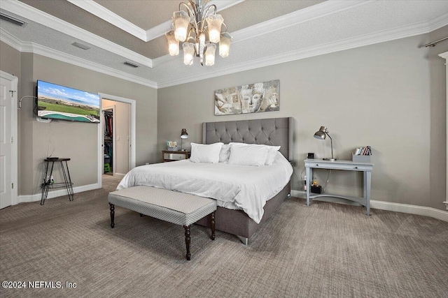 carpeted bedroom featuring crown molding, a spacious closet, a textured ceiling, and an inviting chandelier