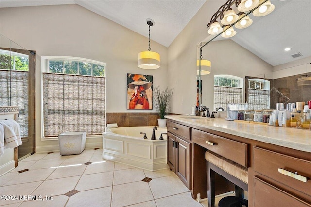 bathroom with vaulted ceiling, plenty of natural light, tile patterned flooring, and vanity