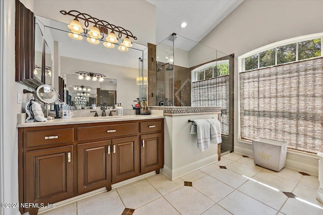 bathroom with a shower, tile patterned flooring, vanity, and lofted ceiling