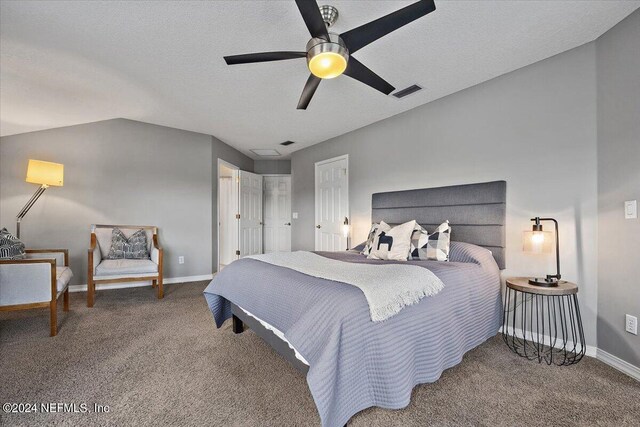 carpeted bedroom with a textured ceiling, ceiling fan, and lofted ceiling