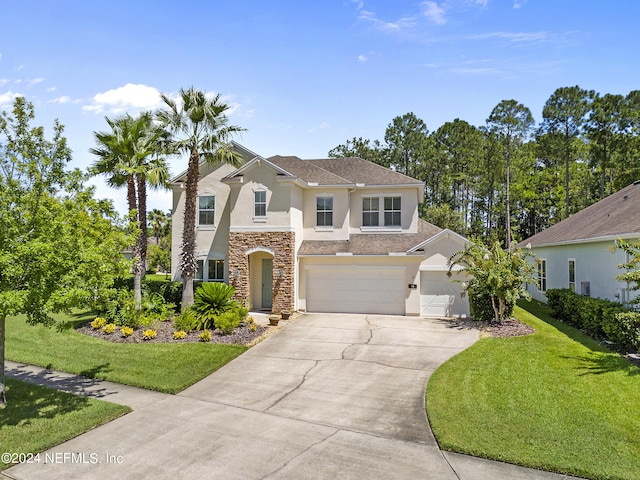 view of front of property featuring a garage and a front lawn