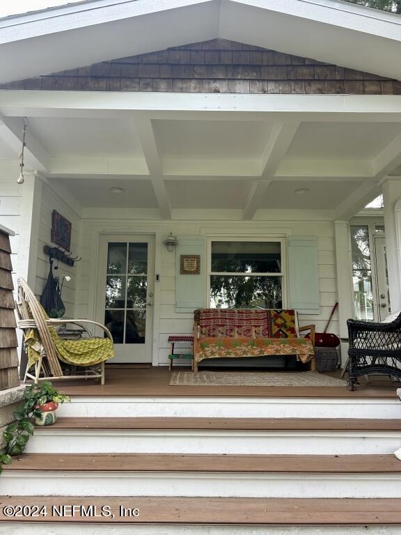 view of exterior entry with a porch