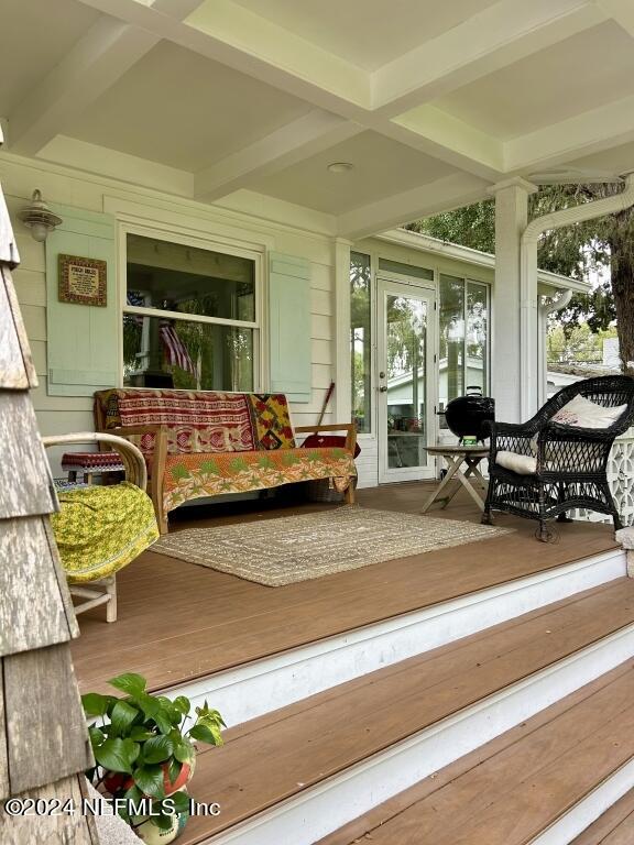 sunroom with coffered ceiling, beamed ceiling, and french doors