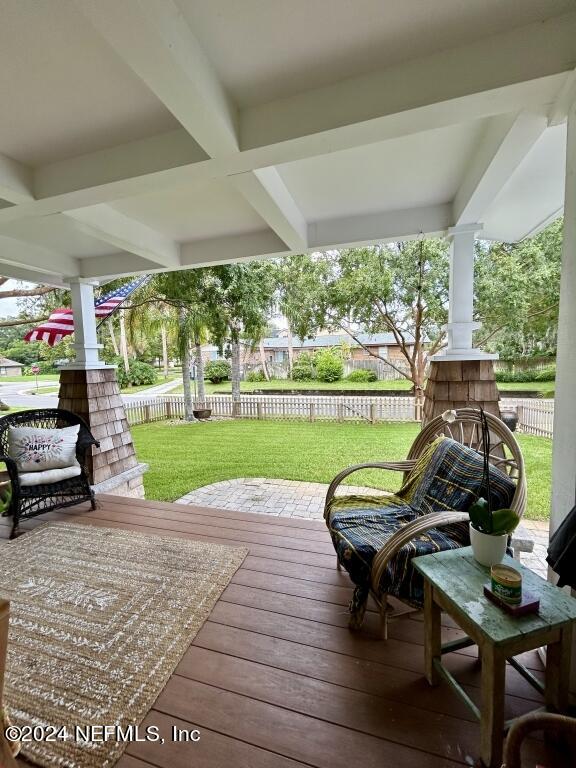 wooden terrace with a lawn