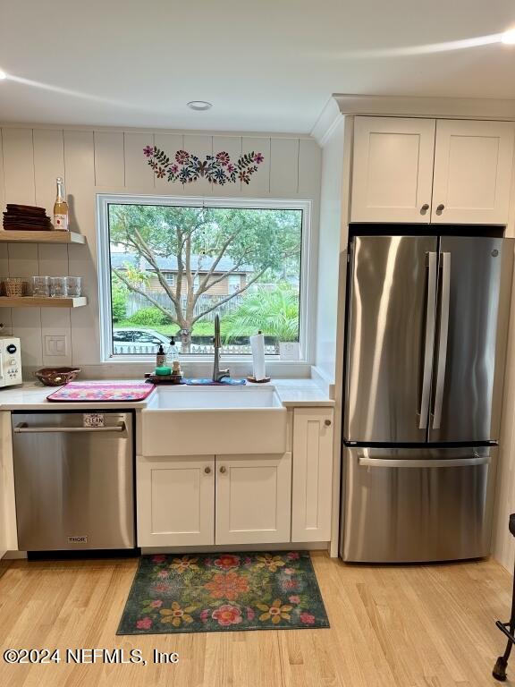 kitchen with a wealth of natural light, light wood-type flooring, and appliances with stainless steel finishes