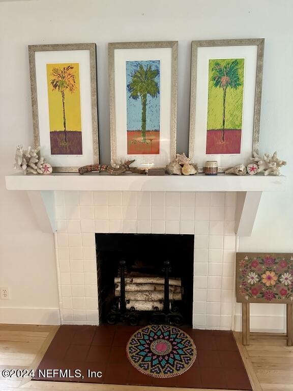 interior details with a fireplace and wood-type flooring