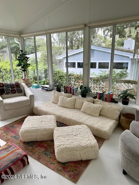 sunroom / solarium featuring a wealth of natural light and lofted ceiling