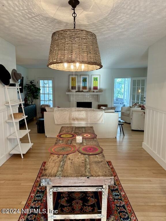 dining room featuring light hardwood / wood-style floors and a textured ceiling