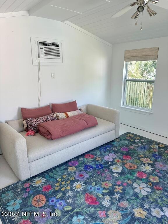 living room featuring ceiling fan, lofted ceiling with beams, and a wall mounted air conditioner