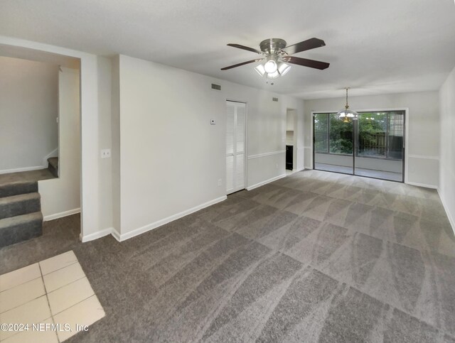 carpeted spare room featuring ceiling fan