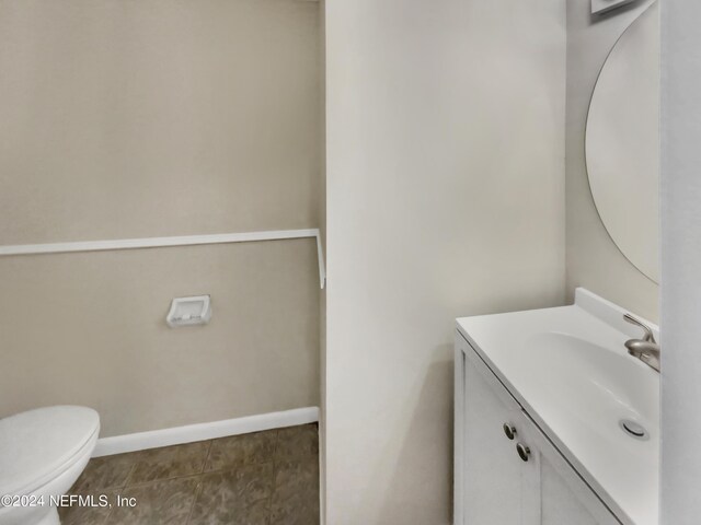 bathroom with tile patterned floors, vanity, and toilet