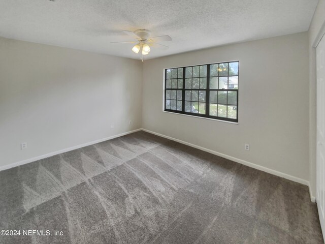 spare room with carpet floors, a textured ceiling, and ceiling fan