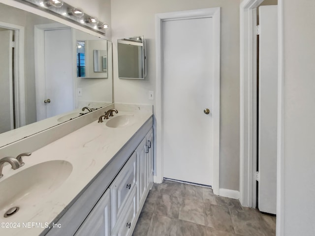 bathroom with dual vanity and tile patterned flooring