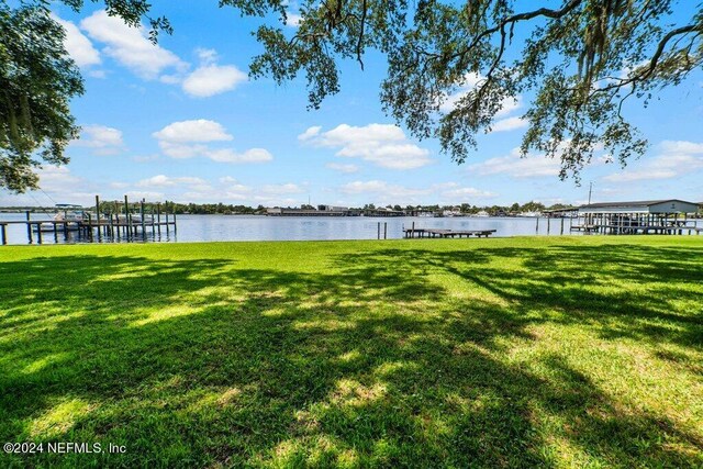 view of yard featuring a dock and a water view