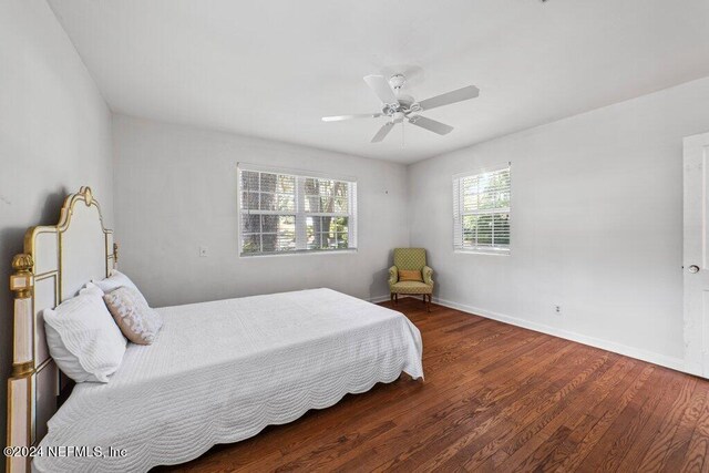 bedroom with dark wood-type flooring and ceiling fan