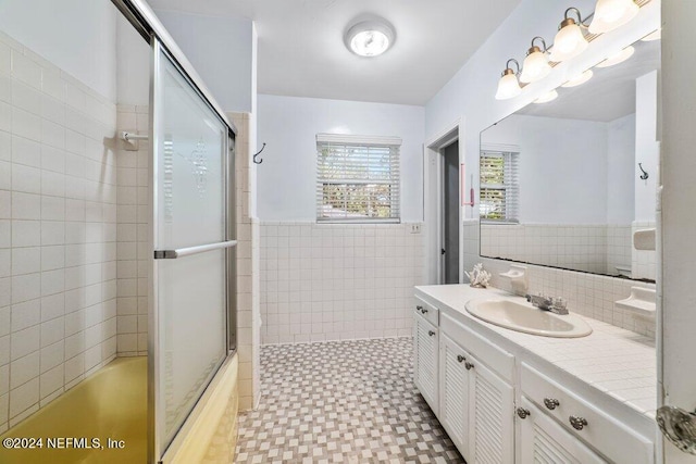 bathroom featuring vanity, tile walls, and a wainscoted wall