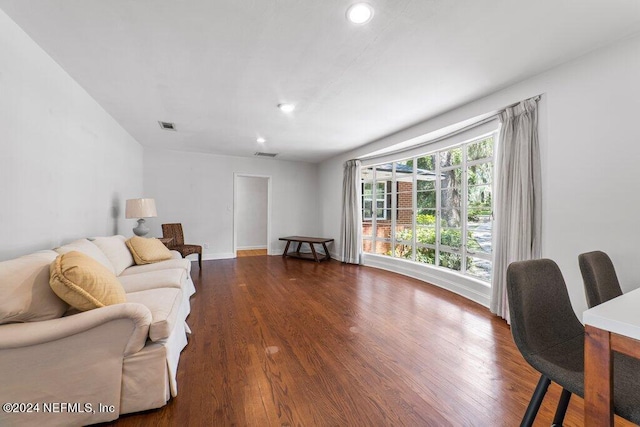 living room with recessed lighting, visible vents, and dark wood-type flooring