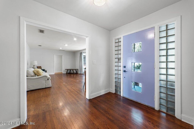 entrance foyer with dark wood-style floors, visible vents, and baseboards