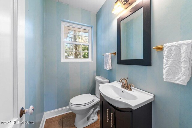 bathroom featuring vanity, toilet, and tile patterned flooring