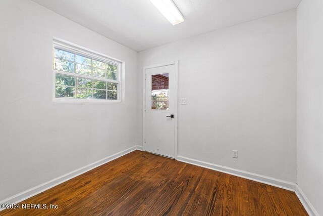 spare room featuring dark wood-type flooring