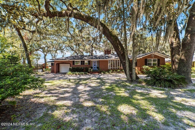 single story home featuring a garage