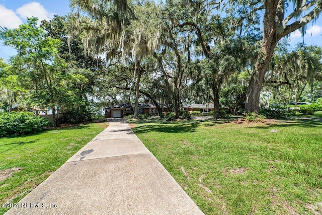 view of home's community with a lawn