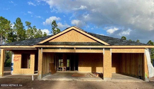 back of property featuring an outbuilding, an exterior structure, and a garage