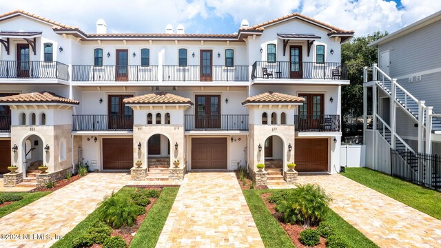 mediterranean / spanish house featuring a balcony and a garage