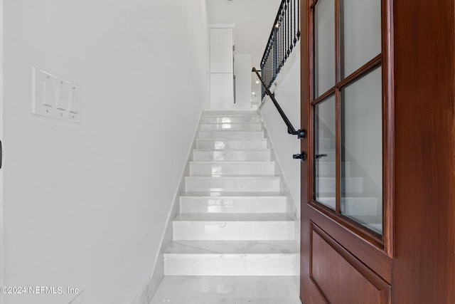 stairs featuring tile patterned flooring