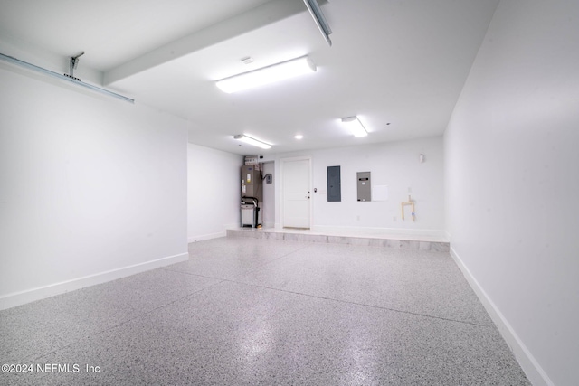 219 11th Ave S, Jacksonville Beach, FL 32250 - garage featuring electric panel, baseboards, and water heater