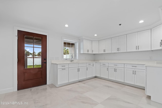 kitchen featuring white cabinetry and sink