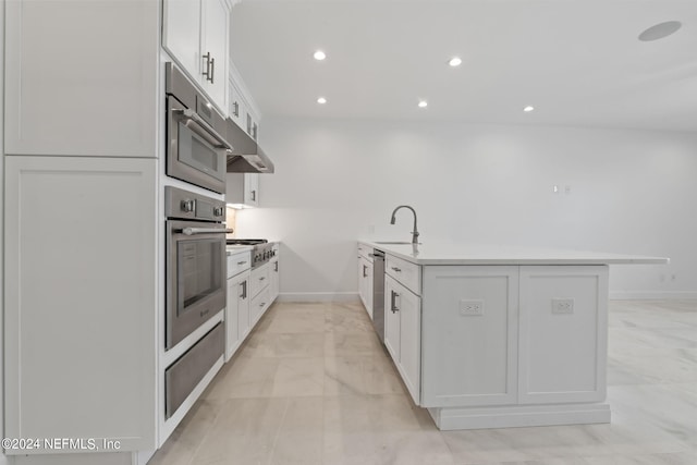 kitchen featuring appliances with stainless steel finishes, kitchen peninsula, white cabinetry, and sink