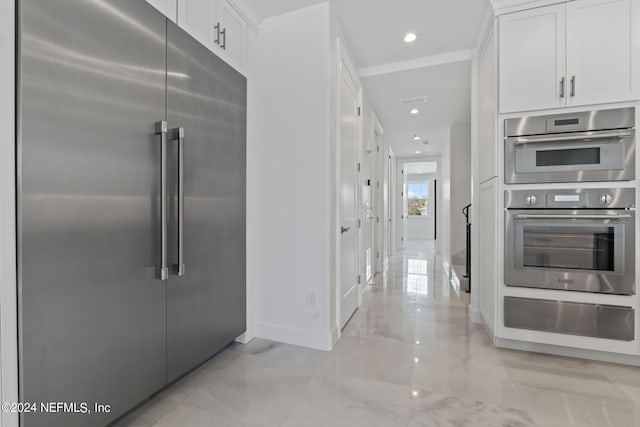 219 11th Ave S, Jacksonville Beach, FL 32250 - kitchen with marble finish floor, white cabinets, a warming drawer, and stainless steel appliances