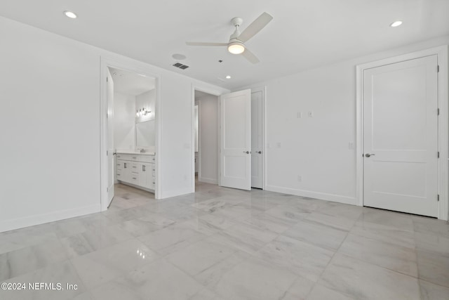 unfurnished bedroom featuring ensuite bathroom and ceiling fan