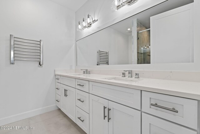 bathroom featuring vanity, radiator, and walk in shower