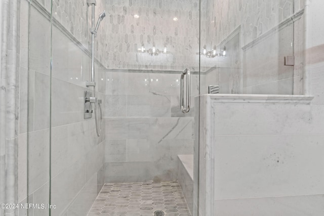 bathroom featuring a shower with door