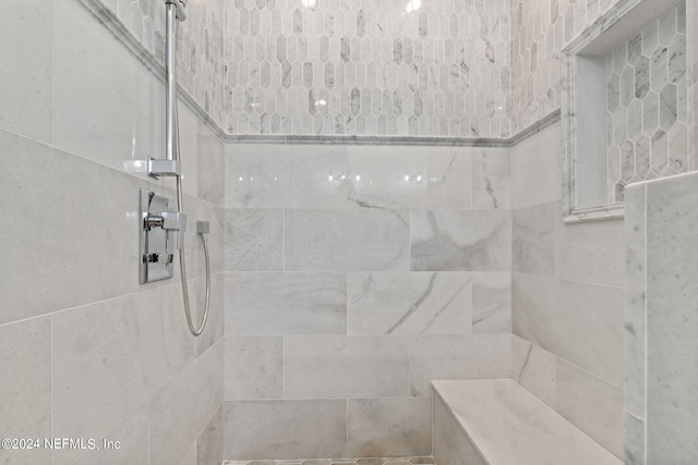 bathroom with a tile shower