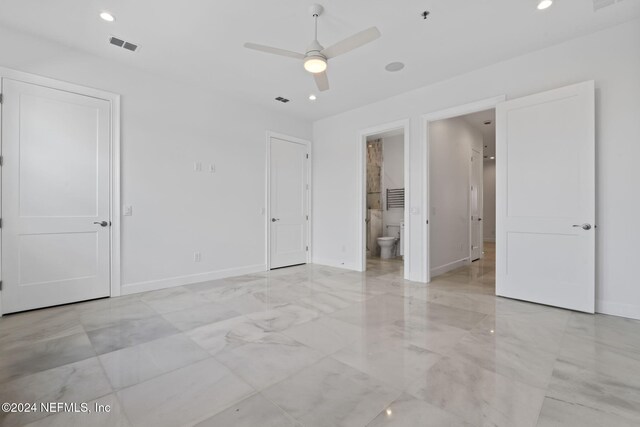 interior space featuring connected bathroom and ceiling fan