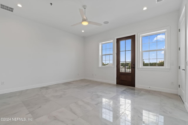 unfurnished room with ceiling fan