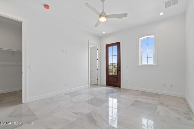 entrance foyer with ceiling fan