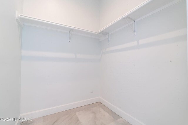 spacious closet with light tile patterned flooring