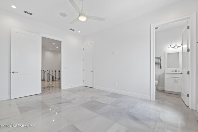 unfurnished bedroom featuring ensuite bath, sink, and ceiling fan