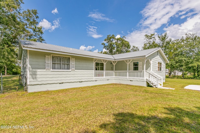 single story home with a front lawn and covered porch