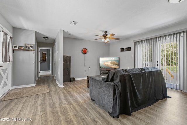 living room with ceiling fan and light hardwood / wood-style floors