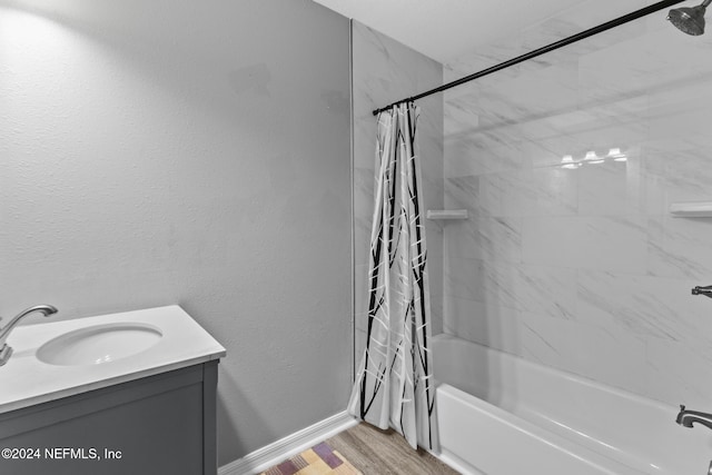 bathroom with vanity, hardwood / wood-style floors, and shower / bath combo