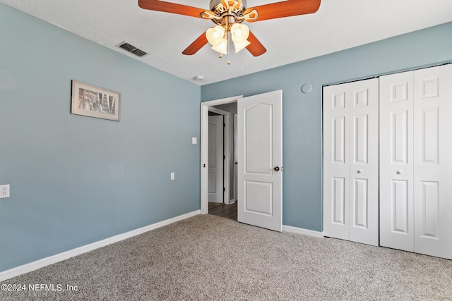 unfurnished bedroom with ceiling fan, a closet, and carpet floors